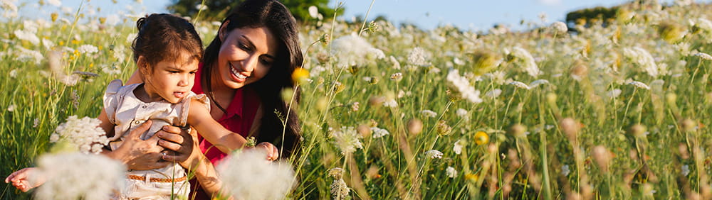 "mother and daughter in field of flowers"