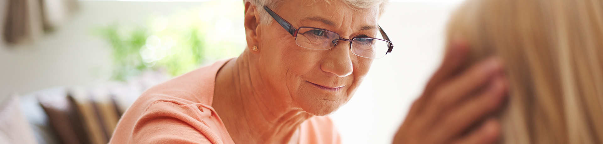 "mother showing compassion touching daughters face"