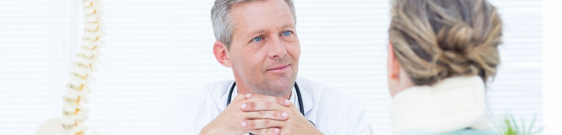 Doctor talking to patient with neck brace