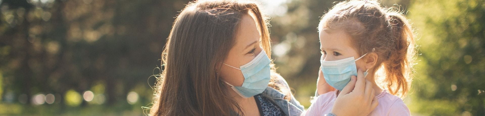 mom and daughter wearing masks